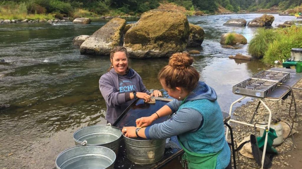Smiling guides washing dishes