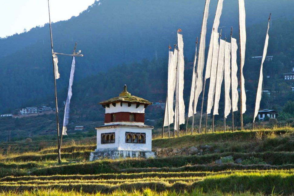 Prayer flags and a stupa on the way to the Temple of the Divine Madman Prayer flags and a stupa on the way to the Temple of the Divine Madman