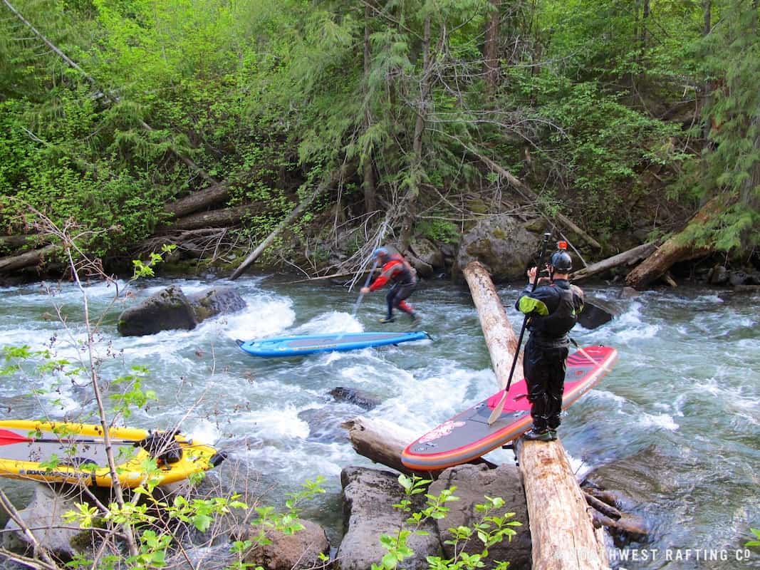 Ryan Saevits portaging a log on the frist SUP descent of Oregon's White River