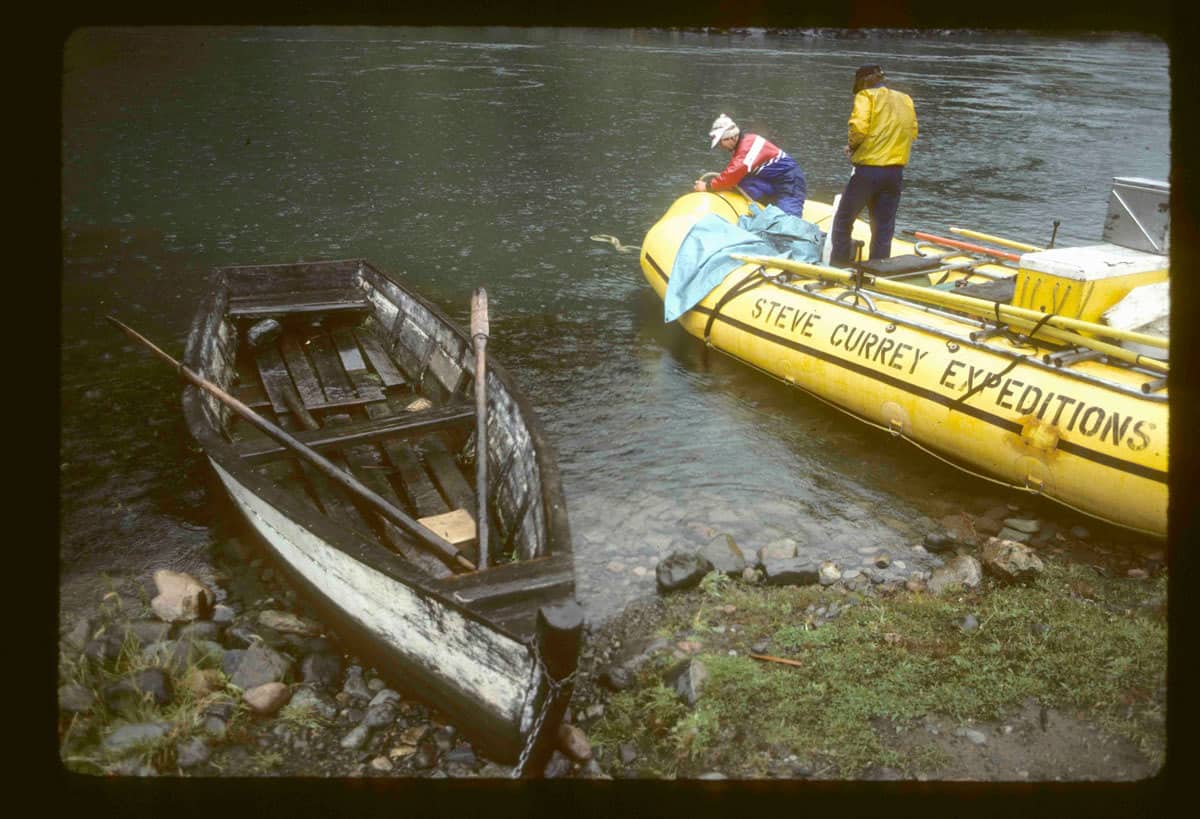1985 first raft expedition on Futaleufú. Daniel Bolster topping off his 22' self bailing Maravia at put-in next to a local rowboat used to reach farms across the river without road access | Photo by Peter Fox