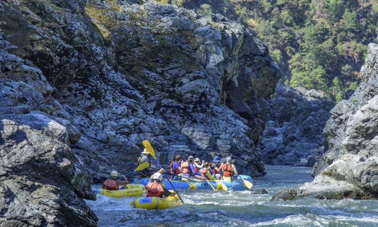 Al Case captures the paddle boat and duckies going through Coffee Pot on the Rogue River