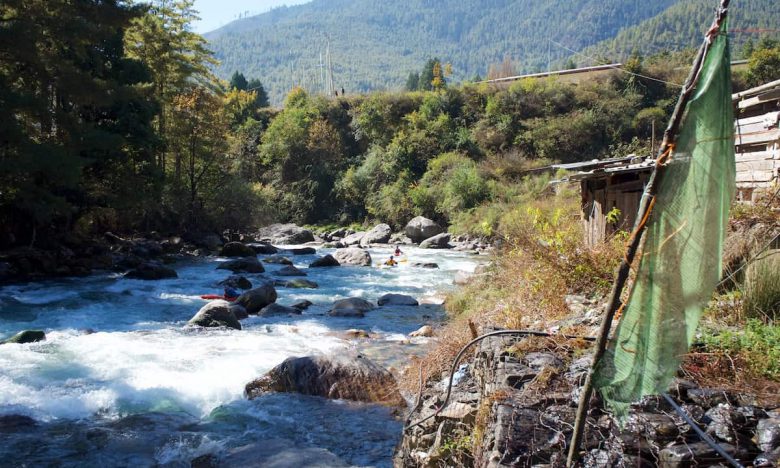 Kayaking by a small village on the Upper Thimphu Chhu