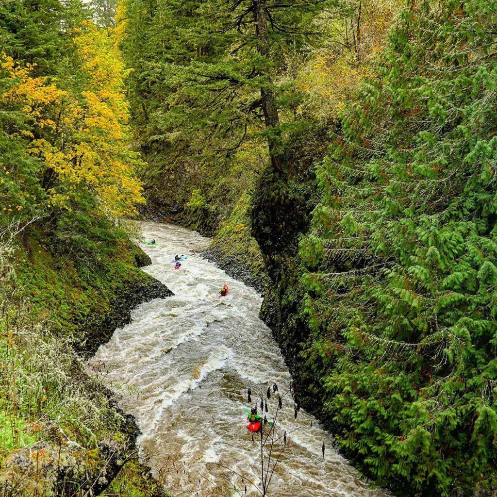 basalt walls, kayakers, brown water