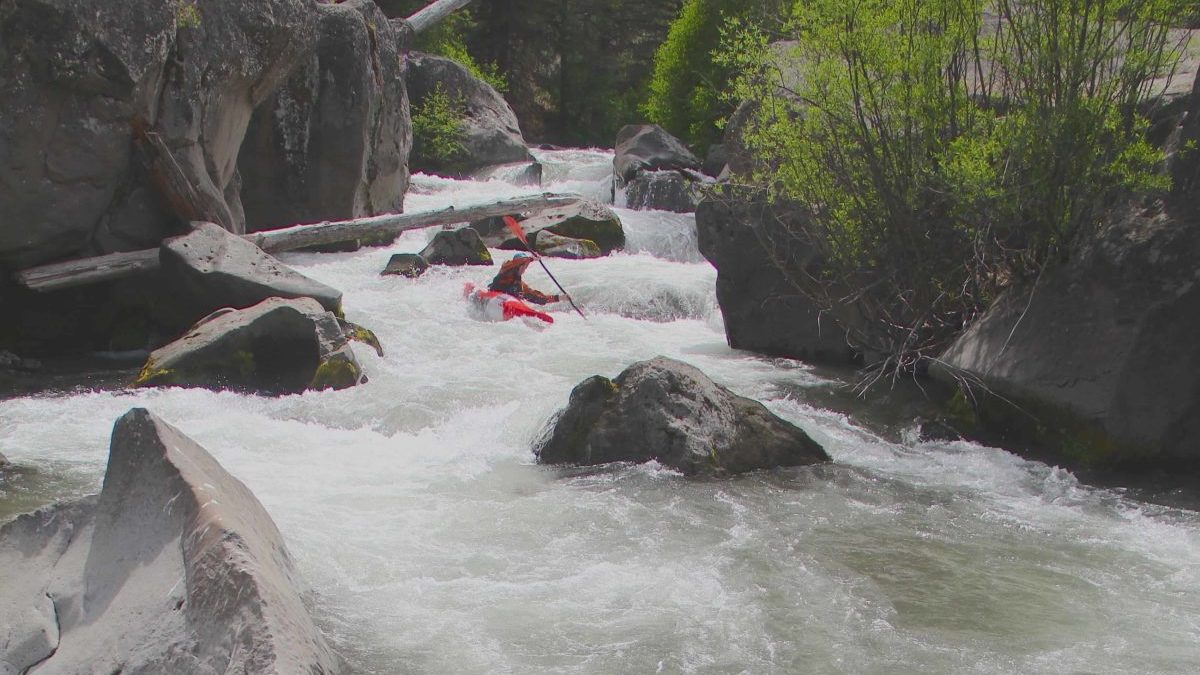 kayaker, boulders, milky water