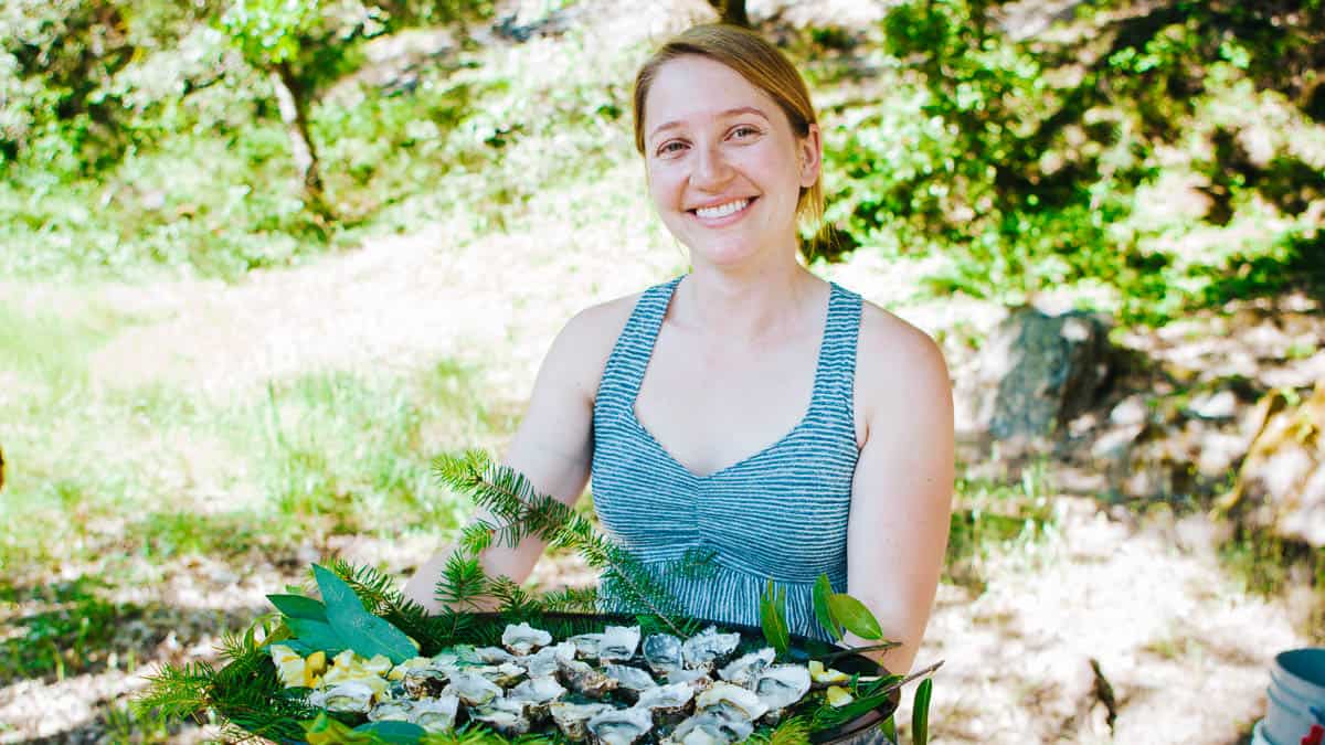 Kaela Fox, Co-Owner of Serenade, showing off some local oysters on the Rogue River