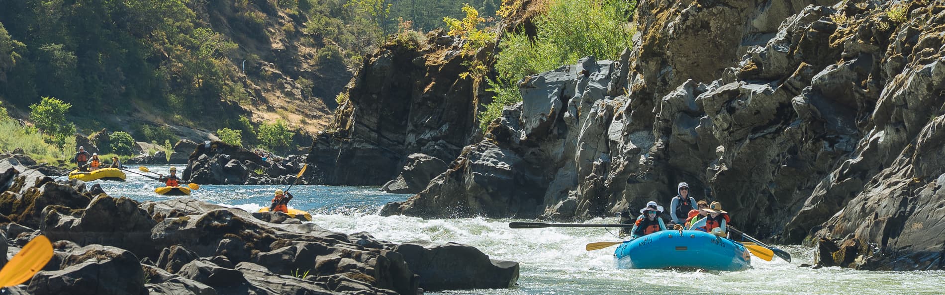 Guided raft navigating a rapid on the Rogue River in Oregon
